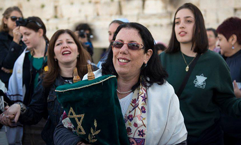 WomanHoldingGreenTorah_featured