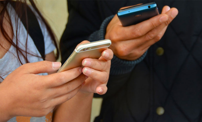 Closeup of Hands Holding Phones