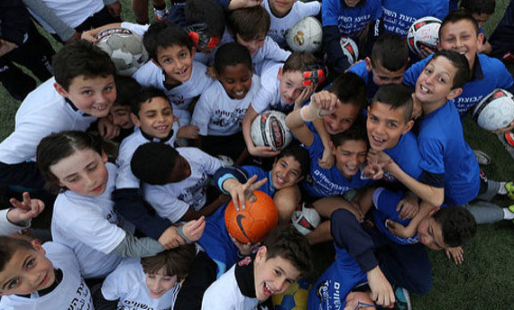 Children playing soccer together
