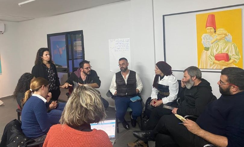 a group of people sitting in a circle having a discussion