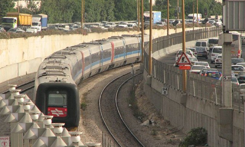 An Israel Railways train snaking through an Israeli city