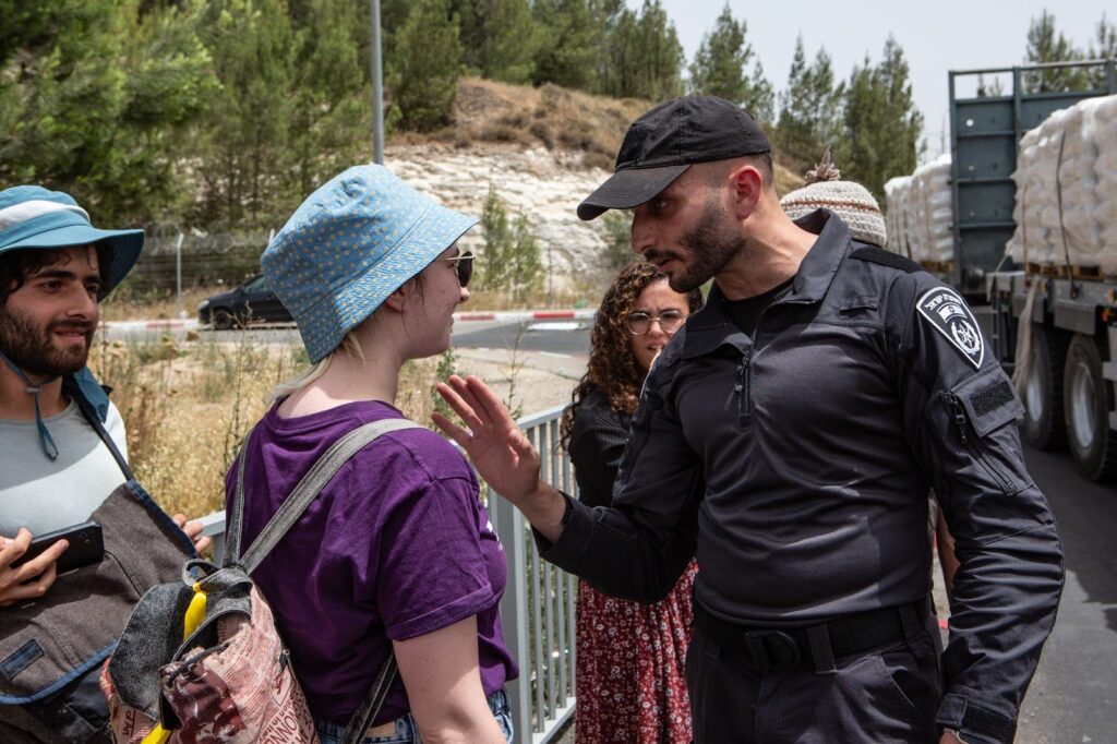 Humanitarian Guard member speaking with Israeli police