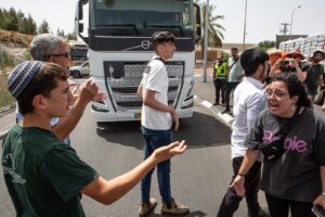 right-wing activists argue with members of the humanitarian guard