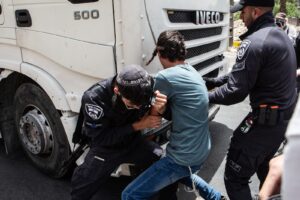 police forcibly remove a right-wing activist from blocking an aid truck