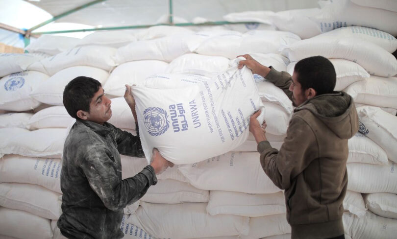 Two men carrying humanitarian aid in Gaza