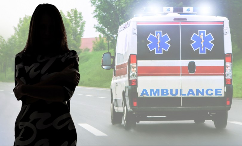 The silhouette of a woman in front of an ambulance