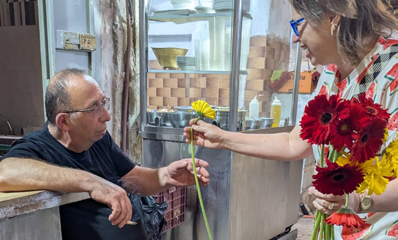 NIF Israel Associate Director Shira Ben-Sasson Furstenberg handing out flowers on Jerusalem Day