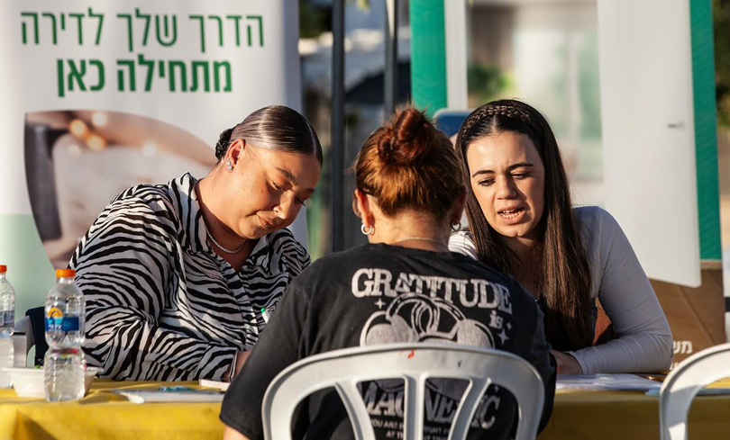 Volunteers at a resource fair in Ofakim